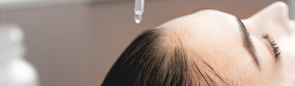 detalle tratamiento capilar mediante gotas en la cabeza de una mujer